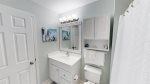 Bathroom with single sink vanity and tub-shower combination